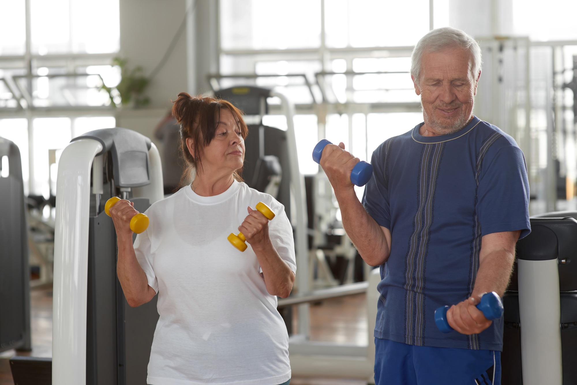 Seniors lifting weights at gym