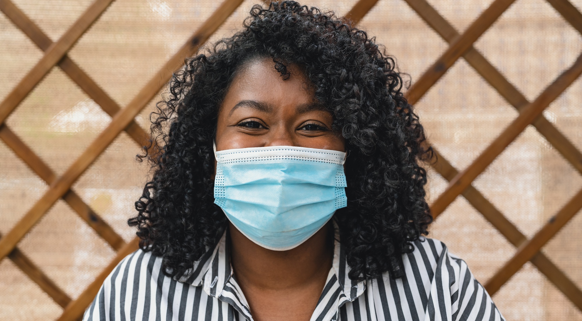 Portrait of African woman wearing face protective mask for preventing spread of corona virus