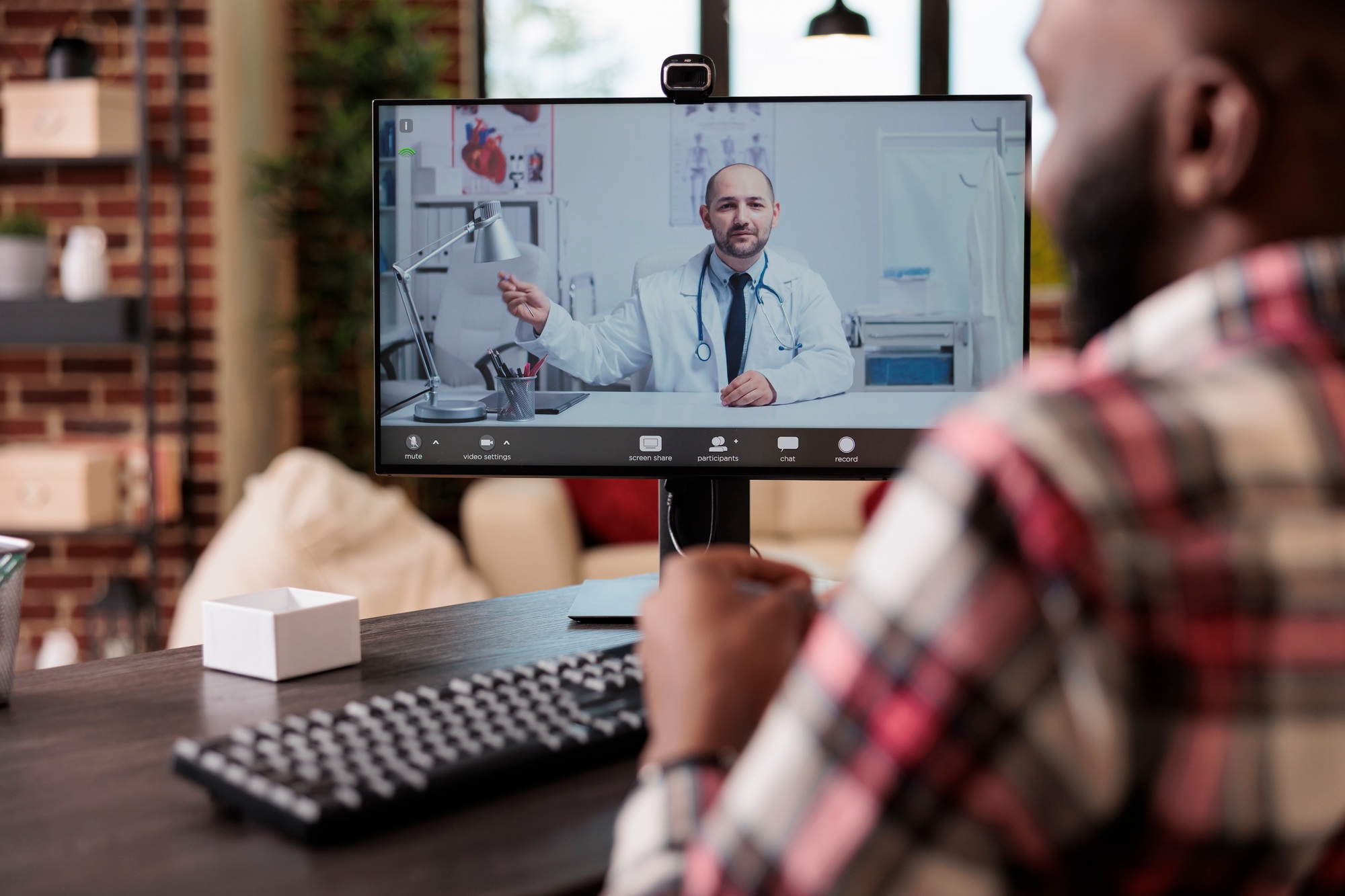 Adult talking to medic on telehealth videocall