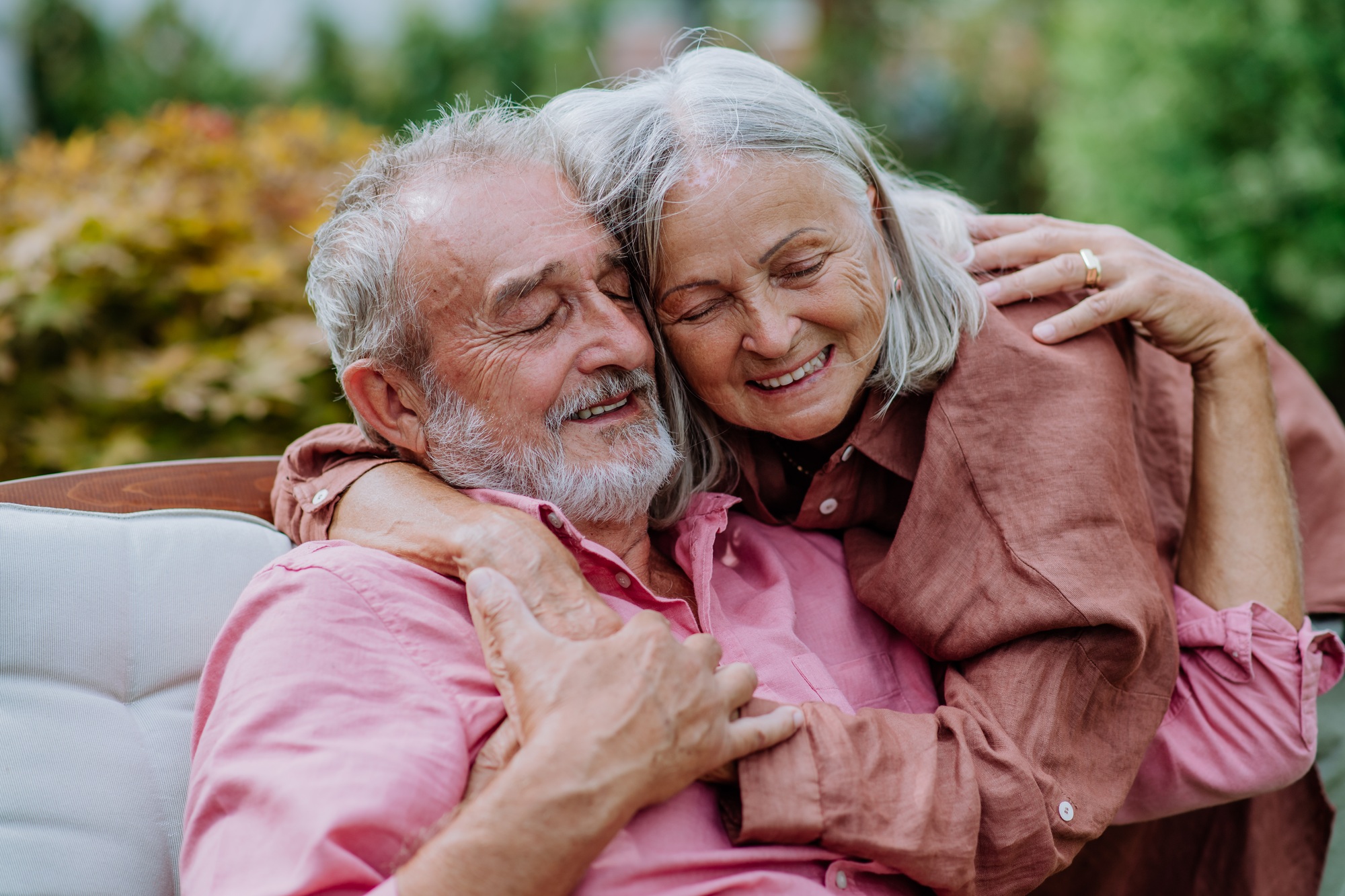 Happy couple relaxing together in their garden.