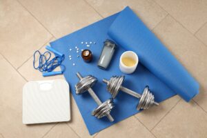 Fitness or sport accessories on fitness mat on floor