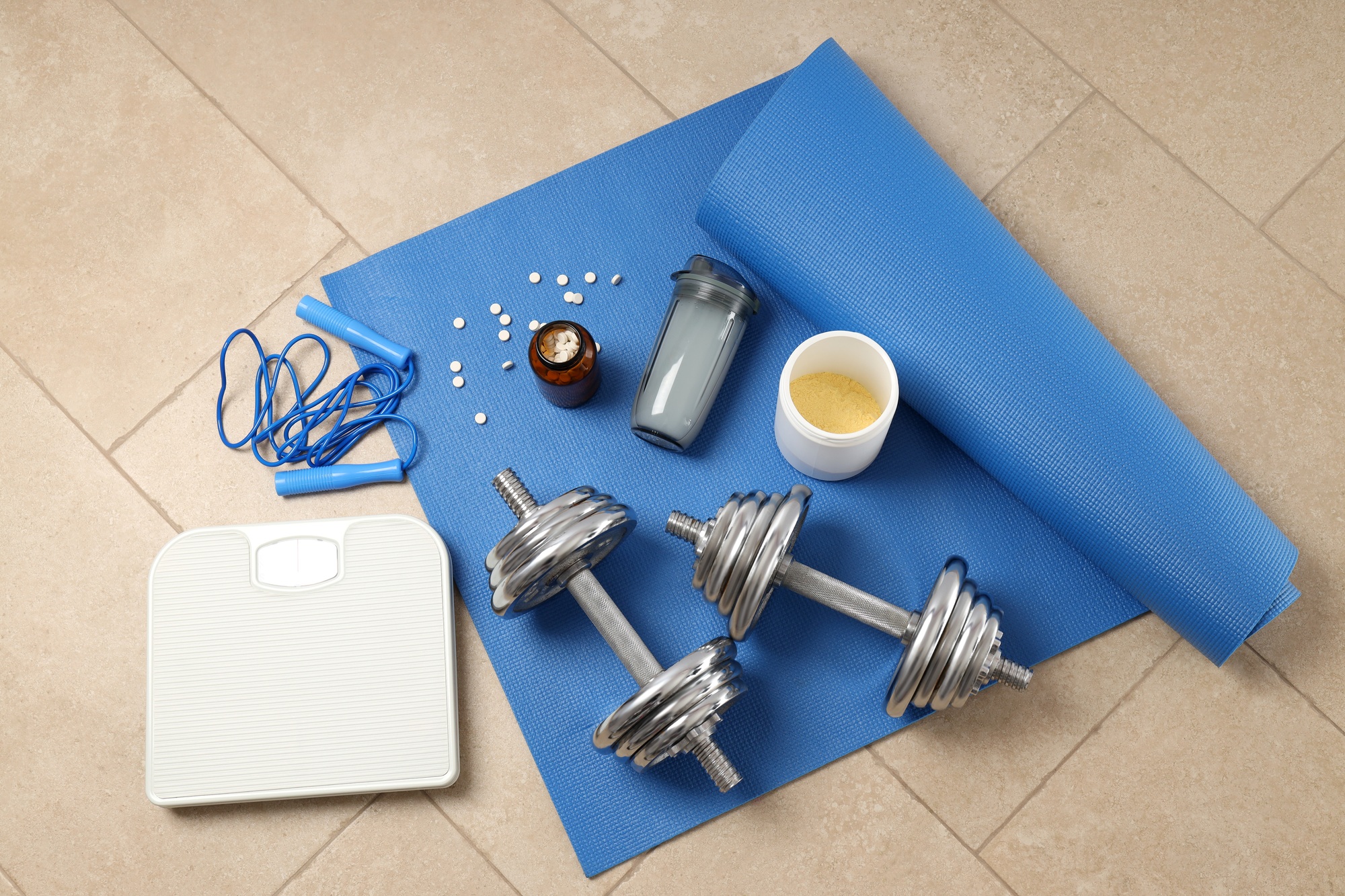 Fitness or sport accessories on fitness mat on floor